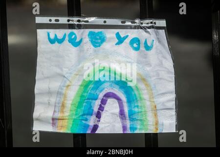 WIMBLEDON LONDON, 14 May 2020. UK. Rainbow drawings (rainbow a symbol of hope and peace) decorating a house window in Wimbledon as a show of support for the NHS (National Health Service) and all essential workers during the Coronavirus pandemic lockdown. Credit: amer ghazzal/Alamy Live News