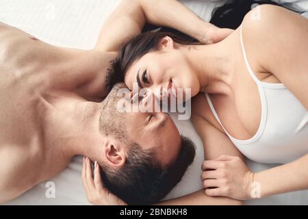 Newly married couple lying face to face Stock Photo