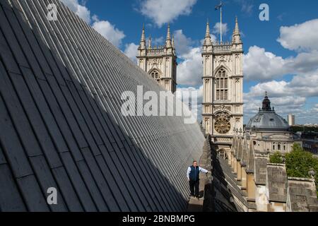 Clerk of the Works Ian Bartlett inspects the main nave roof near the Hawksmoor Towers at Westminster Abbey in London, where a small, dedicated team remains on site in order to care for the 750-year-old building while it is closed during the coronavirus crisis. Stock Photo