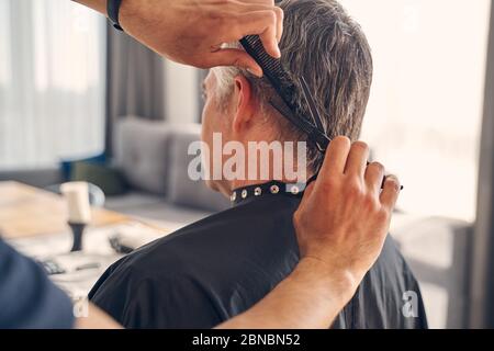 Man getting new trendy hairstyle at home Stock Photo