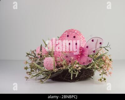 Pink decorative eggs and a butterfly for easter Stock Photo