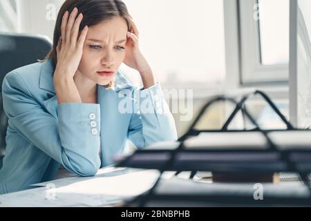Beautiful young woman working in modern office Stock Photo