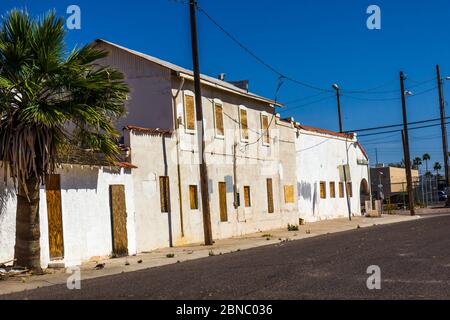 Block Long Two Story Building With Boarded Up Windows And Doors Stock Photo