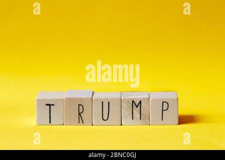 Wooden cubes with the word Trump on orange background, President America concept