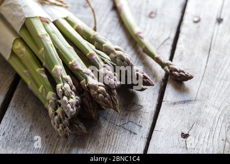 green Asparagus. Bunches of green asparagus on a grey wooden rustic background Stock Photo