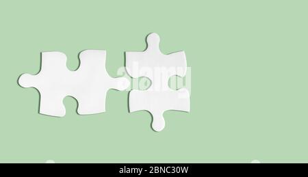 Paper puzzle pieces mockup isolated on green background. Ideal matching, partnership concept. Metaphor of teamwork, hr, problem solving. Creative busi Stock Photo