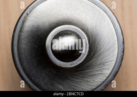 Macro, close-up view of a brushed metal door knob on kitchen cupboard. Abstract background. Stock Photo