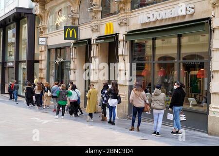 Bordeaux , Aquitaine / France - 05 12 2020 : people queue waiting for shopping on sidewalk outside shop  zara Mc Donalds during quarantine for COVID-1 Stock Photo