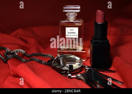 Kolkata, India on 13th May in 2020 : Chanel perfume bottles isolated on red background. Different Chanel perfume products with female accessories. Stock Photo