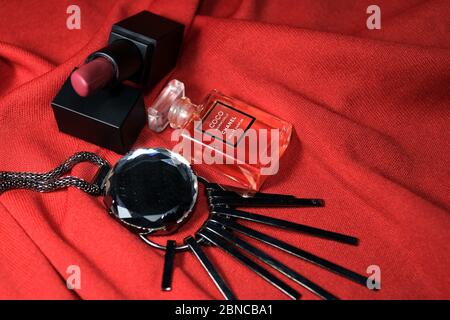 Kolkata, India on 13th May in 2020 : Chanel perfume bottles isolated on red background. Different Chanel perfume products with female accessories. Stock Photo