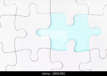 Missing piece of jigsaw puzzle on blue background. Completing final task. Looking for men male. Uncompleted puzzle. Solving problem concept. Stock Photo