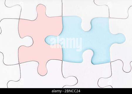 Male and female pieces of puzzle matching each other. Missing piece of jigsaw puzzle on blue background. Looking for love partner. Uncompleted puzzle. Stock Photo