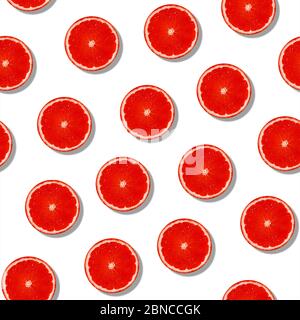 Seamless grapefruit with shade pattern on white surface. Colorful fresh citrus slice pattern. Creative color, summer friuts concept. Minimal style. Stock Photo