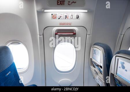 Emergency exit door in an airplane Stock Photo