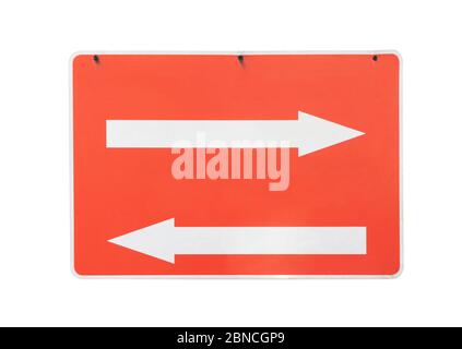 scuffed red and white metal sign with two white arrows, one pointing left and one pointing right, hanging on 3 rusty screws. One 255 white background Stock Photo