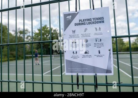 Brockwell Park, UK. 14th May 2020. A 'Playing tennis during lockdown' sign at the tennis courts in Brockwell Park following Government advice that lockdown rules have been relaxed for a small number of sports. Tennis, along with golf and basketball, have been cited as a sport that can be played safely, while keeping two metres apart. Brockwell Park is a 50.8 hectare park located south of Brixton, in Herne Hill and Tulse Hill in south London. (photo by Sam Mellish / Alamy Live News) Stock Photo