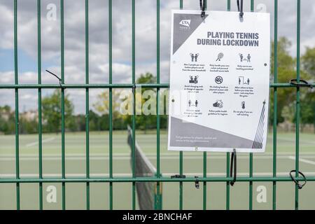 Brockwell Park, UK. 14th May 2020. A 'Playing tennis during lockdown' sign at the tennis courts in Brockwell Park following Government advice that lockdown rules have been relaxed for a small number of sports. Tennis, along with golf and basketball, have been cited as a sport that can be played safely, while keeping two metres apart. Brockwell Park is a 50.8 hectare park located south of Brixton, in Herne Hill and Tulse Hill in south London. (photo by Sam Mellish / Alamy Live News) Stock Photo
