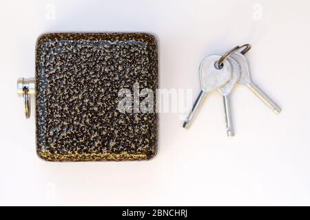 Padlock metal lock crab and three keys top view. Large heavy padlock with reinforced security and steel keys. The lock is square for guarding the area Stock Photo