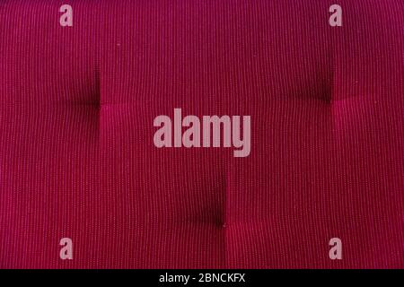 A fragment of the upholstery of the sofa of red color close up Stock Photo