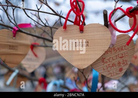 Shizuoka, Japan - March 23, 2019: View of the heart wooden tag of Mishima Skywalk hangs on the tree, a pedestrian bridge officially known as the Hakon Stock Photo