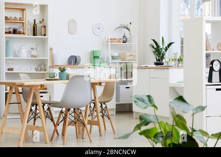 Image of white modern kitchen with big table and modern chairs in the house Stock Photo