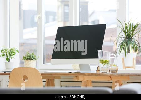 Image of big computer monitor on the wooden table at office Stock Photo