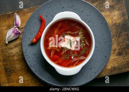 Borscht on a dark background top view. Russian or Ukrainian traditional soup. Flat lay, close-up Stock Photo