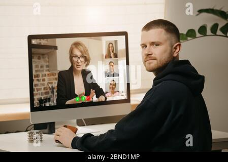 A fellow distracted from an online briefing at home. Stock Photo