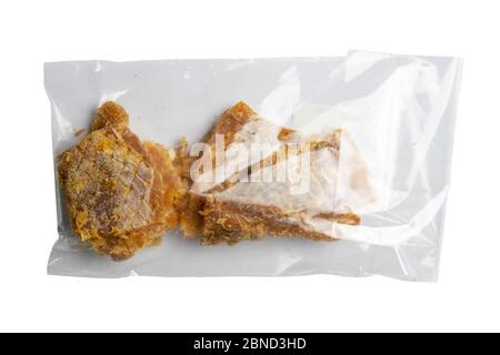 Dried cod with pepper in a transparent package appetizer to beer isolated on white background. Snack Fish to beer. Close up Stock Photo