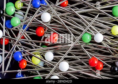 brightly colored pins lying all over the place Stock Photo