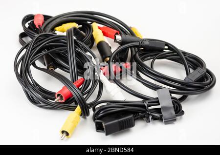 Close-up  pile of analog  rca cables  for connection between camcorder, dvd player, blu-ray on white  background. Stock Photo
