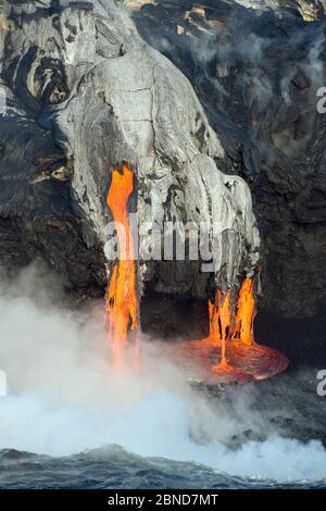 Red hot lava from Kilauea Volcano flowing into ocean at Puna, Big Island, Hawaiian Islands, USA, January 2013. Stock Photo