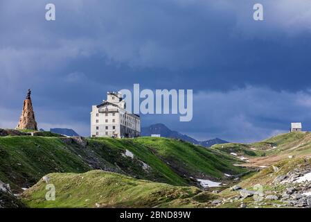 The Petit-Saint-Bernard hospice,  and statue of Saint Bernard de Menthon at the Little St Bernard Pass, French Italian border, Alps, June 2015 Stock Photo