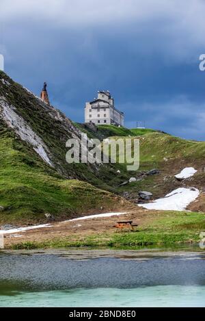 The Petit-Saint-Bernard hospice,  and statue of Saint Bernard de Menthon at the Little St Bernard Pass, French Italian border, Alps, June 2015 Stock Photo