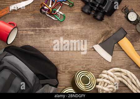 top view of backpack and hiking equipment on wooden table Stock Photo