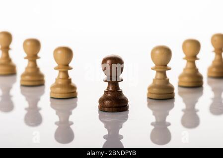 Selective focus of brown pawn with another on white background Stock Photo