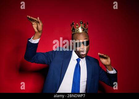 Closeup photo of handsome attractive dark skin business guy bossy person dancing office event golden diadem on head wear sun specs formalwear suit Stock Photo