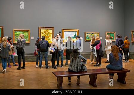 Art museum visitors enjoying art at The National Gallery, London