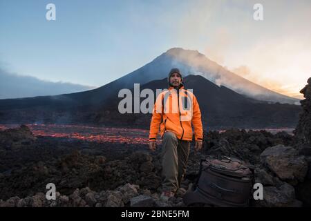 Photographer Pedro Narra standing in front of Fogo Volcano after eruption, Fogo Island, Cape Verde, 29th November 2014. Stock Photo