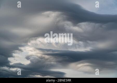 Interesting unusual lenticular clouds. Dramatic sky Stock Photo