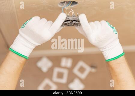 Electrician builder install working switches and sockets black color loft style Stock Photo