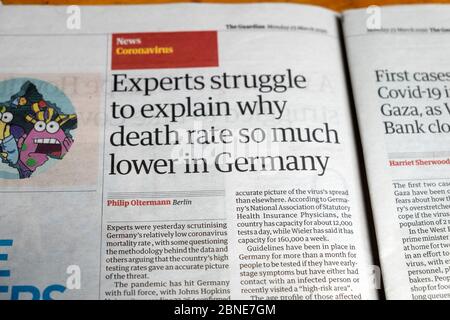 Guardian newspaper inside page Covid headline article clipping 'Experts struggle to explain why death rate so much lower in Germany'  March 2020 UK Stock Photo