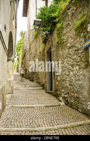 LAKE COMO, ITALY - JUNE 2019: Person walking up cobbled steps on the route of the Greenway del Lago di Como, which runs around part of Lake Como Stock Photo