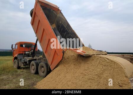 dump truck sand moving unloads orange bournemouth articulated following beach alamy