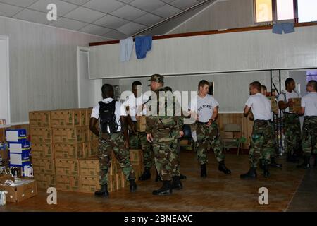 BILOXI, UNITED STATES - Sep 06, 2005: Air Force personnel carry and stack supplies for Hurricane Katrina victims. Stock Photo