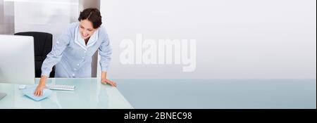Cleaning Office Computer And Desk. Professional Cleaner Stock Photo
