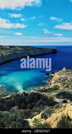 Vertical shot of the beautiful Fomm Ir-Rih Bay Cart Ruts in Mġarr, Malta on a sunny day Stock Photo