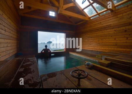 Person in White sulphur hotsprings, Chichagof island, South East Alaska, USA, July. Model released Stock Photo