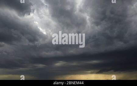 Dark clouds, dramatic storm background. Abstraction of weather conditions. Stock Photo