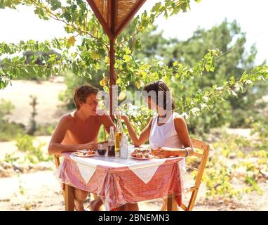 Young couple eating in Greek Taverna, near Sidari, Corfu, Ionian Islands, Greece Stock Photo